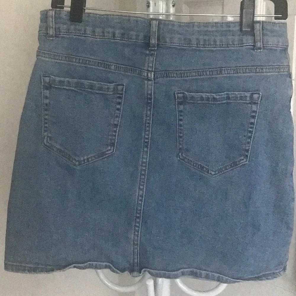 Fray features blue denim skirt with free knit top